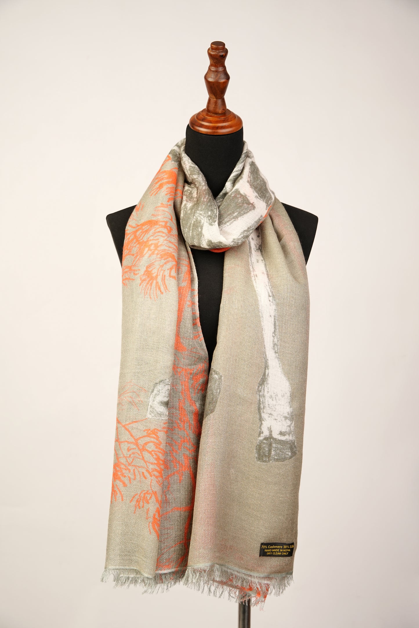 The safari sunset cashmere and silk shawl features a giraffe and fox print pattern.