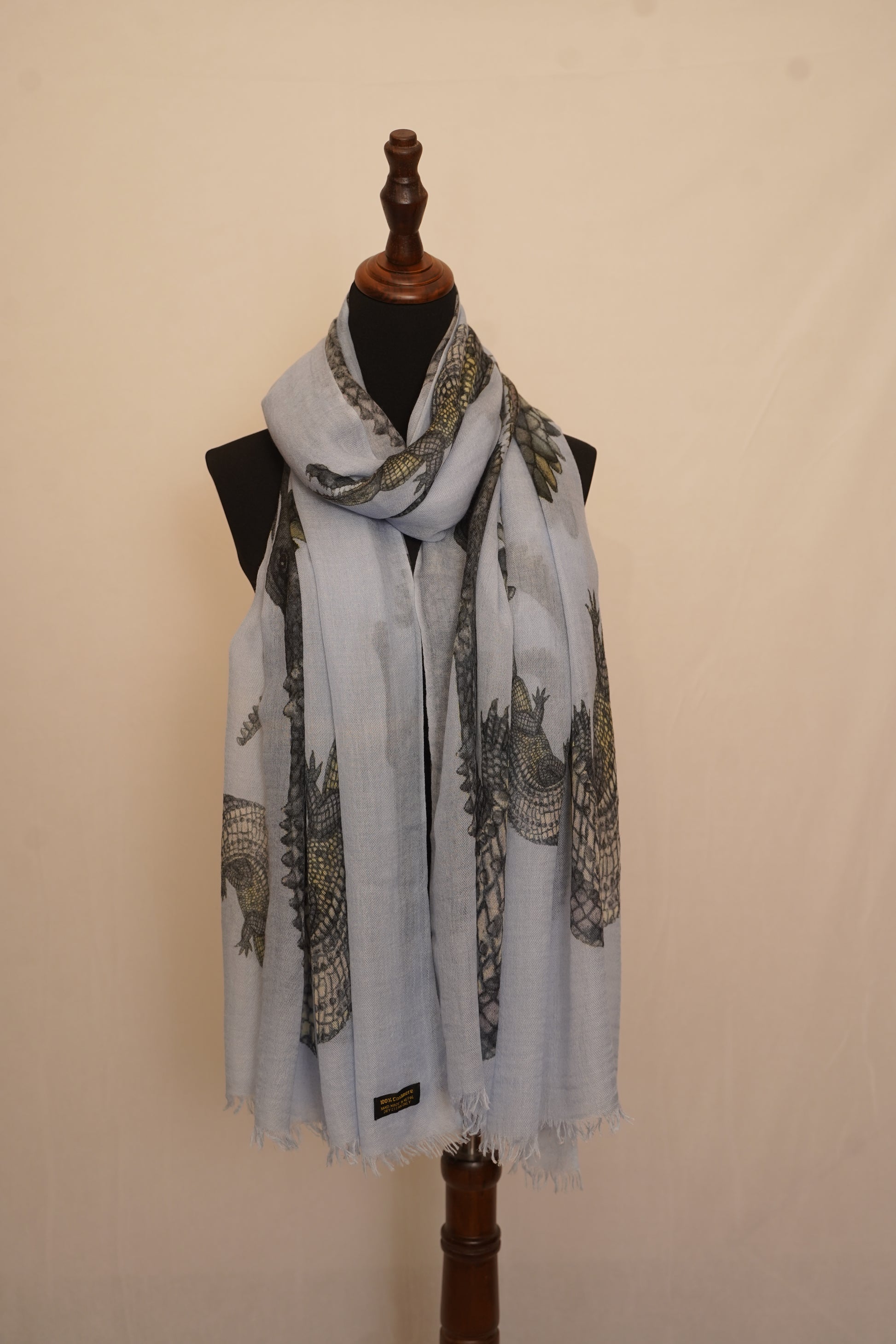 A pure cashmere scarf with bold reptile print enhances your class and aesthetic. 