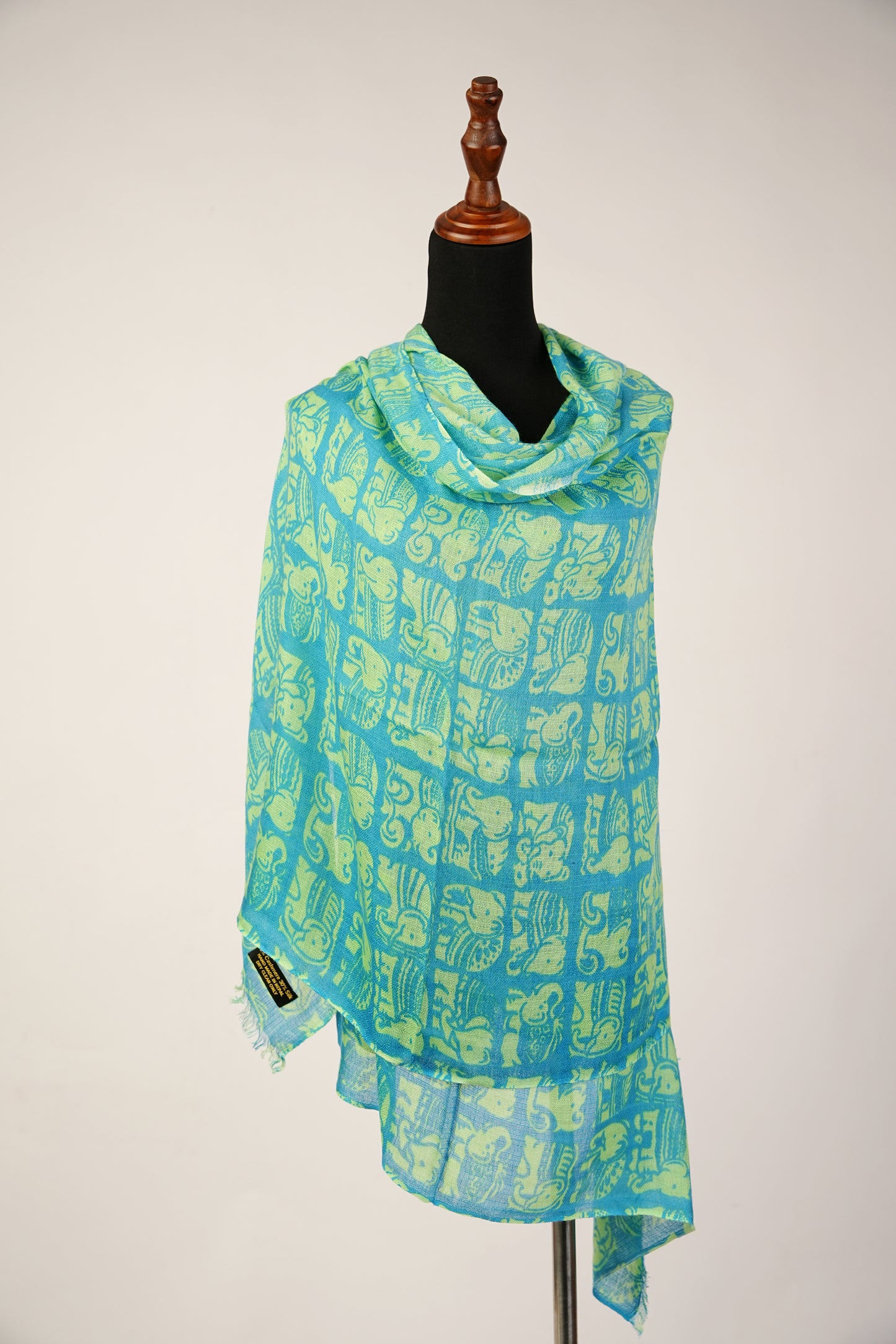 Featuring a shawl print of Asiatic Elephants, crafted from a blend of cashmere and silk.