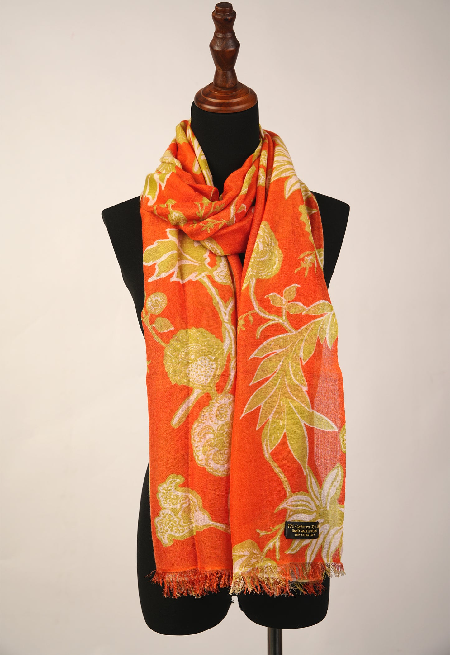 The stole is a brilliant combination of tiger orange and floral print, made from luxurious cashmere and silk.