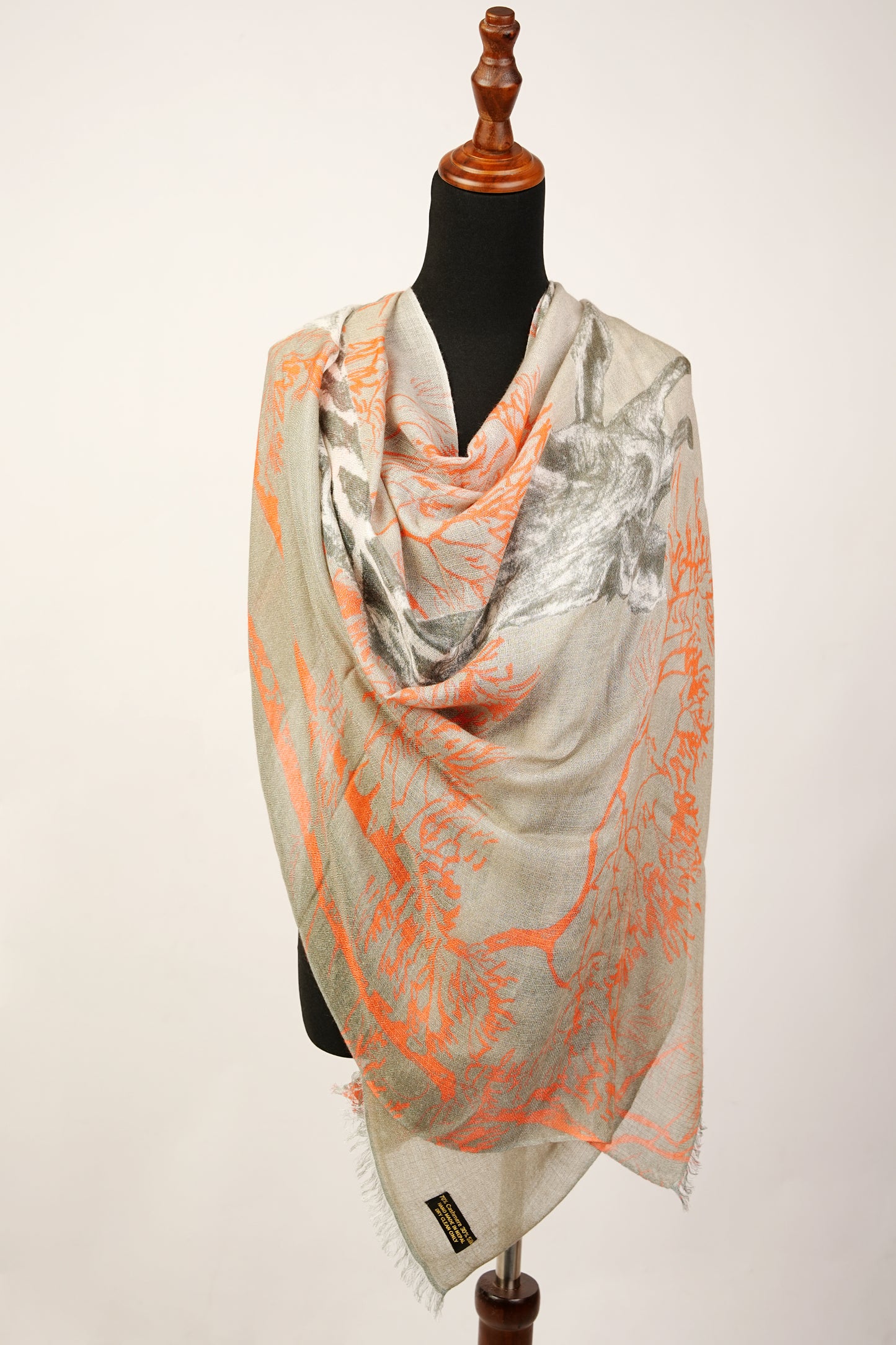 The safari sunset cashmere and silk shawl features a giraffe and fox print pattern.