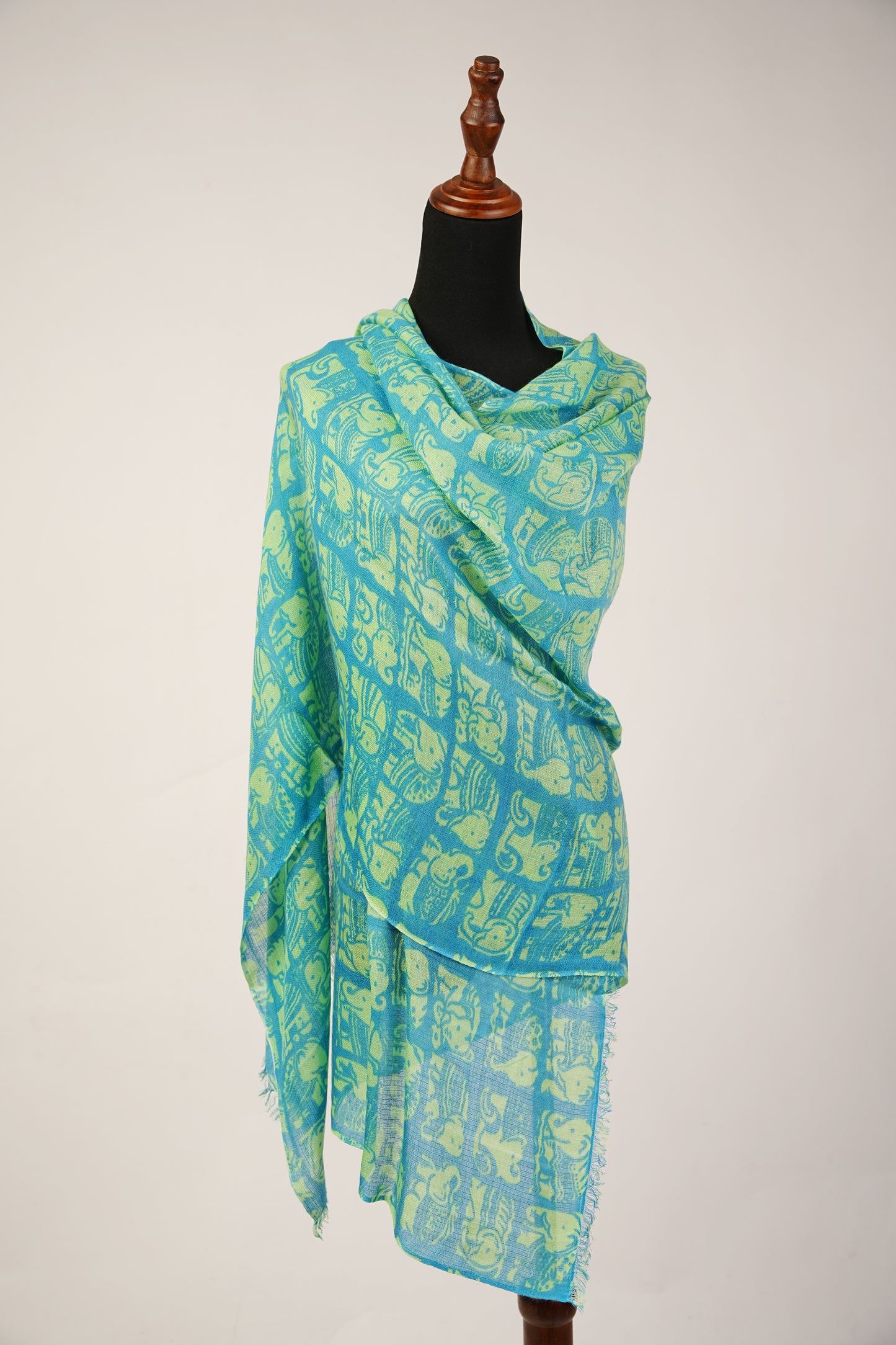 Featuring a shawl print of Asiatic Elephants, crafted from a blend of cashmere and silk.