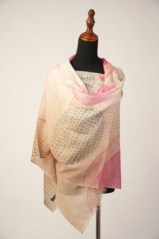 The shawl is made of soft cream cashmere and features an abstract print.