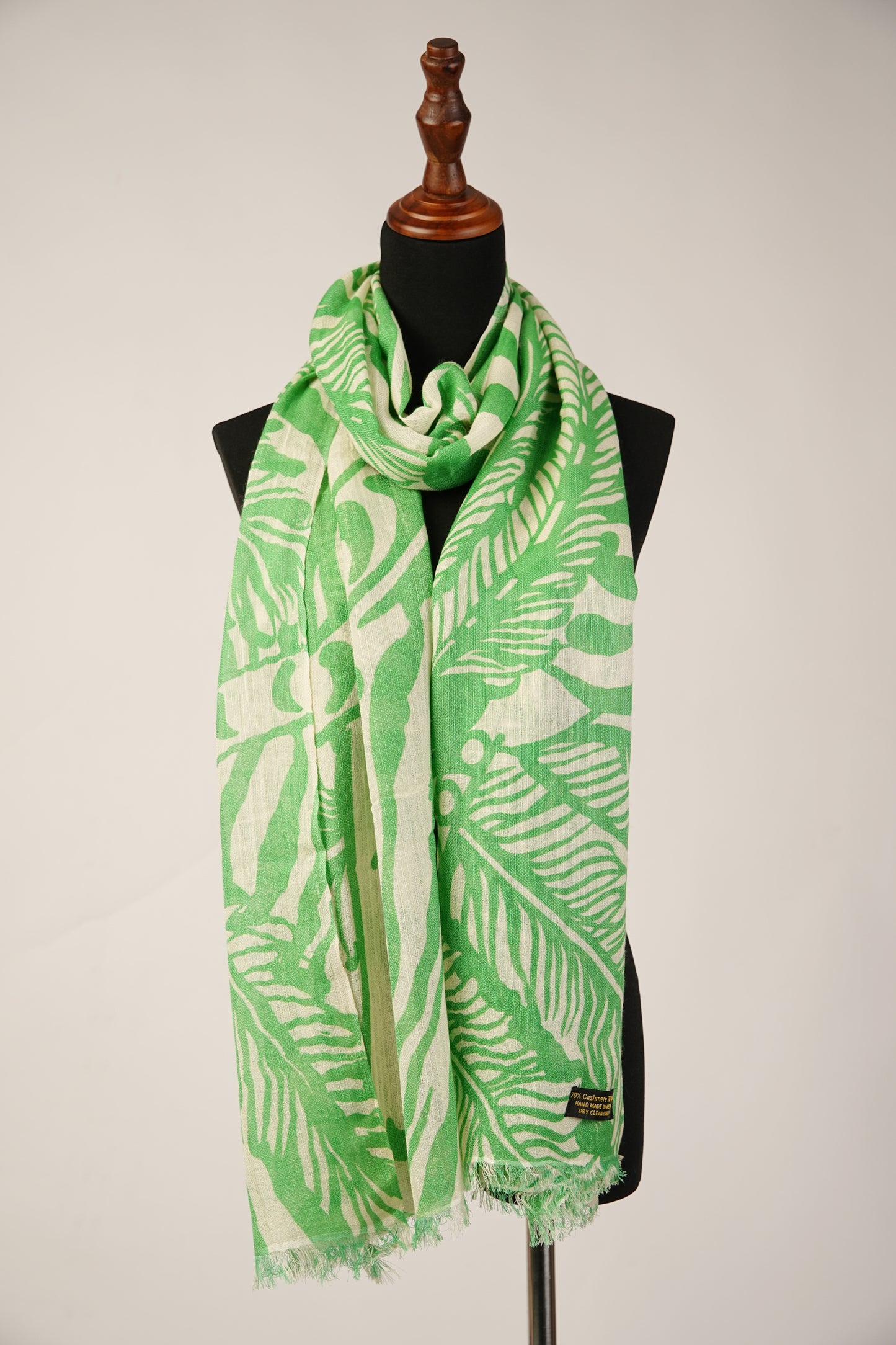 A green cashmere and silk blend shawl with a palm leaf pattern