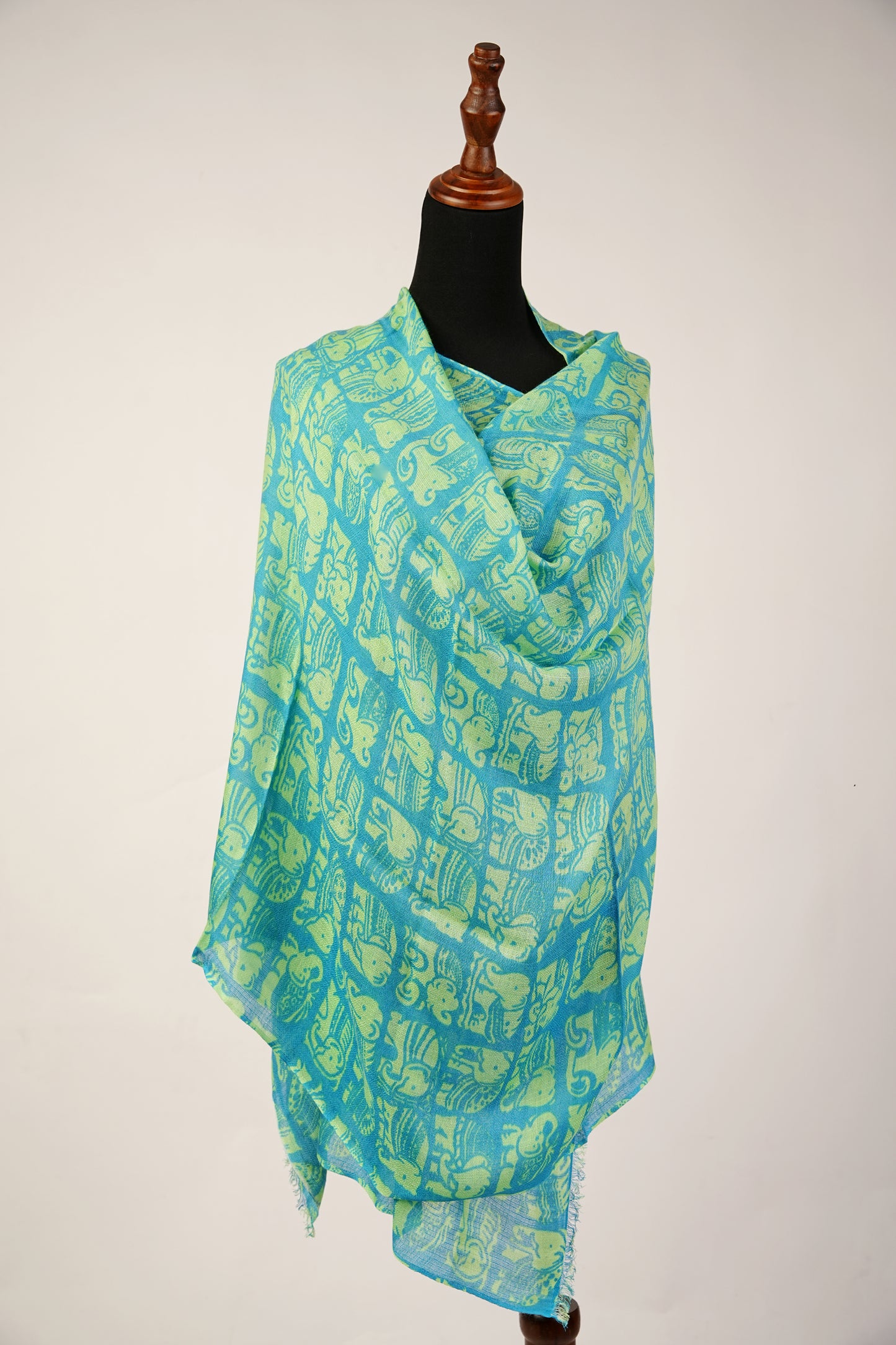 Featuring a shawl print of Asiatic Elephants, crafted from a blend of cashmere and silk.