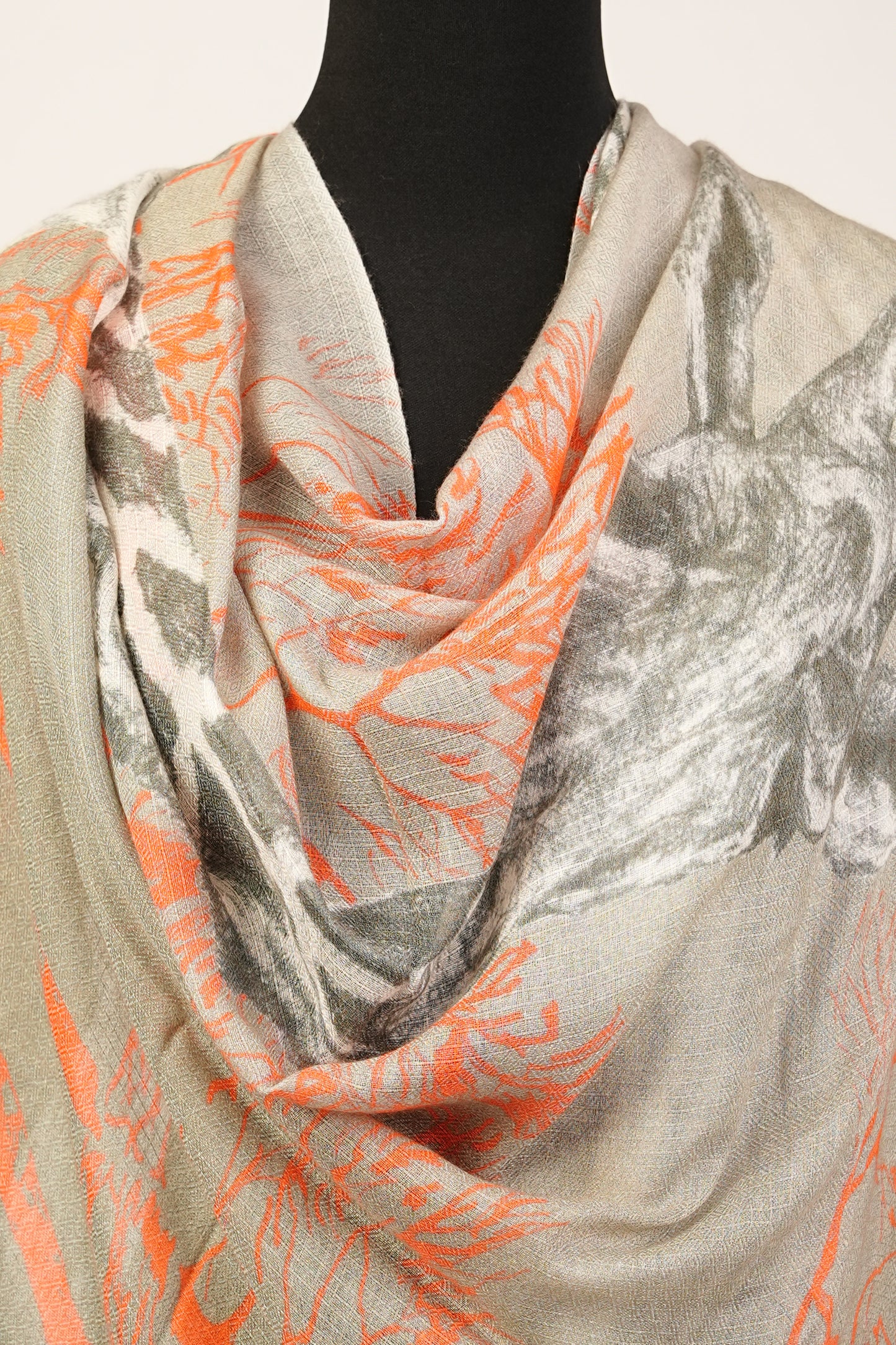 The safari sunset cashmere and silk shawl features a giraffe and fox print pattern.