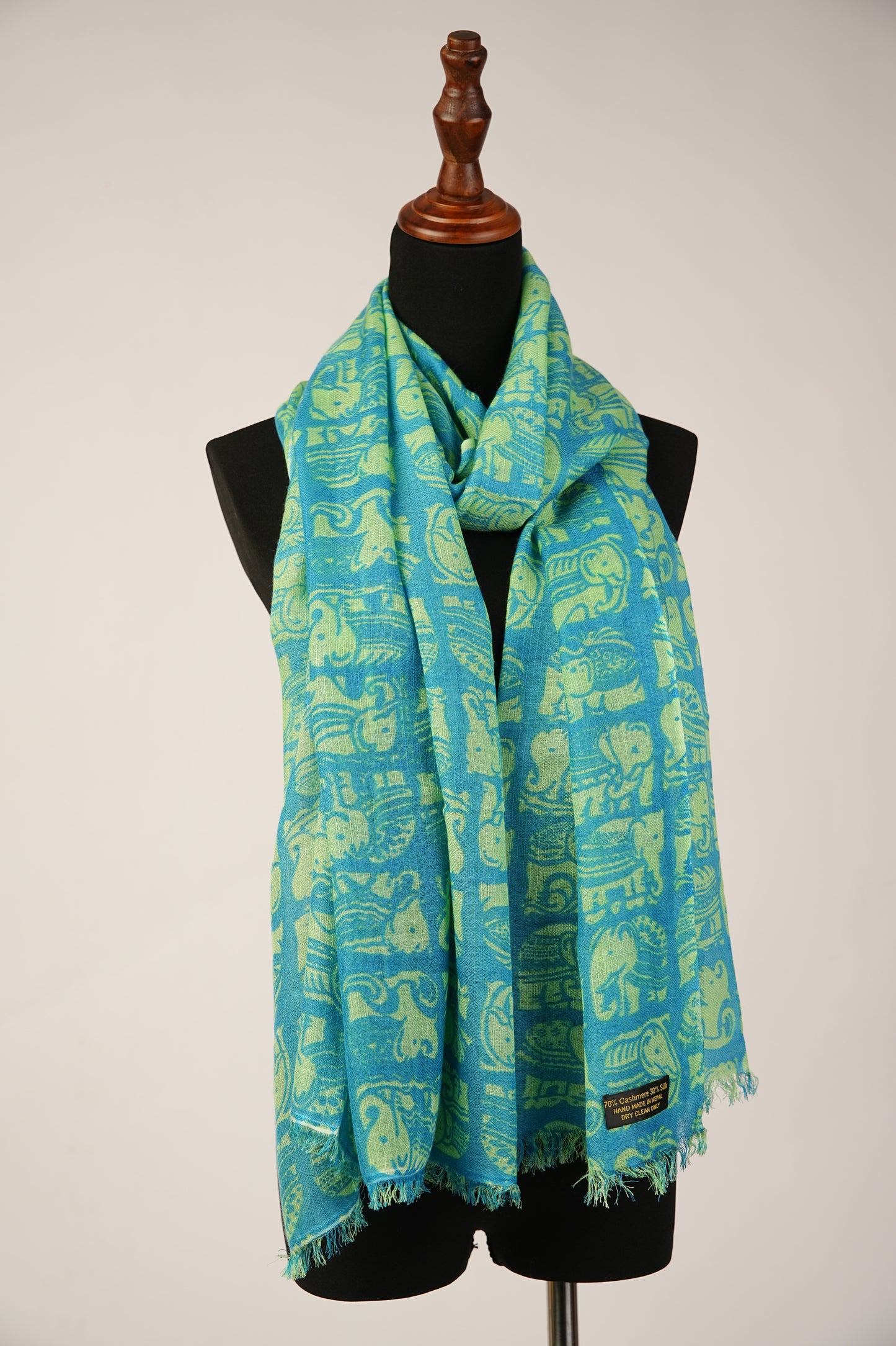 Featuring a shawl print of Asiatic Elephants, crafted from a blend of cashmere and silk.